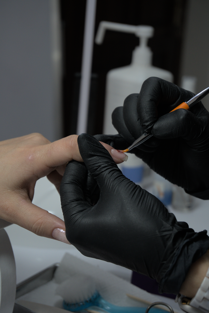 Close-up of a manicure, showcasing skilled nail art application in a salon.